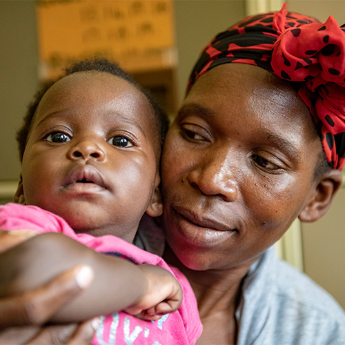 A mother and daughter wait to be tested at an HIV clinic in Kihihi, Uganda. Photo by New Horizons Collaborative, 2021. (photo)