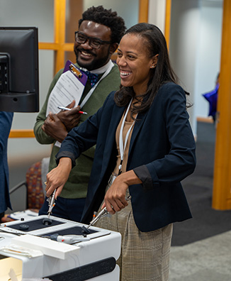 Wilson M. Aloubia, M.D., MSc., and LaDonna Kearse, M.D., practice their laparoscopic skills in a surgical training lab during Diverse Surgeon Initiative 2.0. (photo)