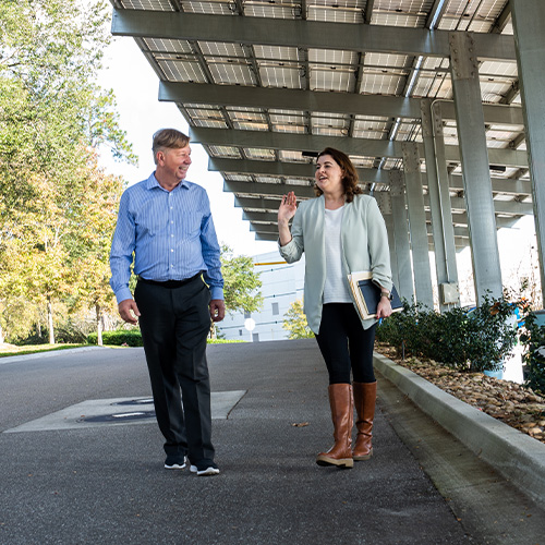Employees walking under Jacksonville Vision Distribution Center's Solar Carport (photo)