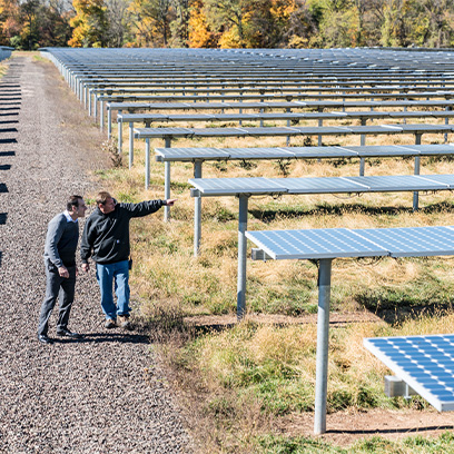 Employees walk through the solar panel field at the J&J Innovative Medicine site in Titusville, NJ (photo)