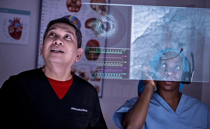 two medical professionals looking at a transparent screen (photo)